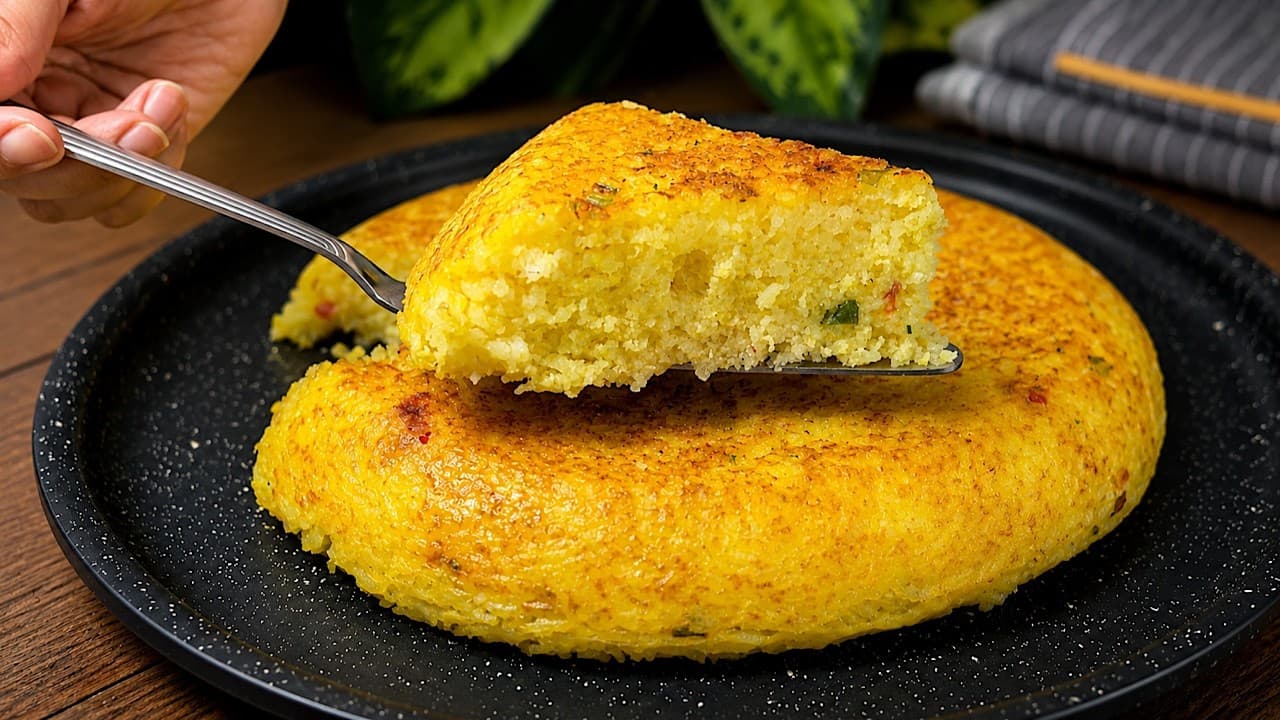 Golden crispy saffron rice and egg cake sliced into wedges on a serving dish